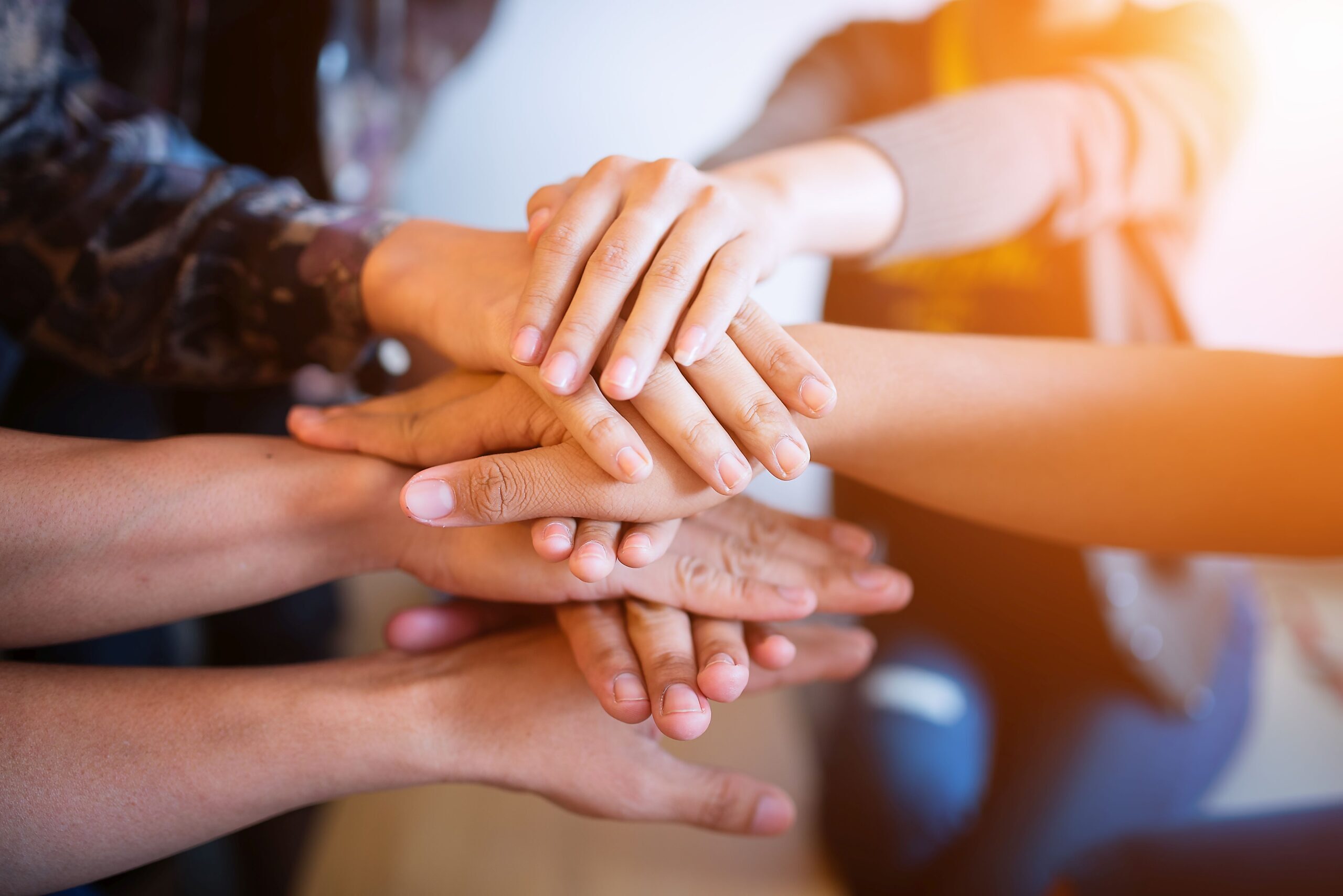 Teamwork putting their hands together,join hands partnership and teamwork concept.
